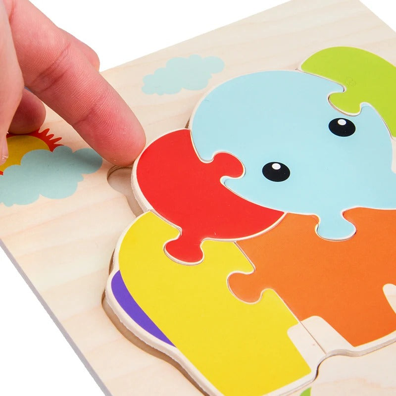 Gros plan main assemble puzzle  éléphant multicolore encastrement - qualité bois enfant - Atelier Puzzle